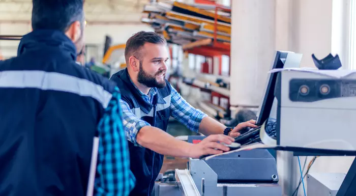 Two workers and a screen